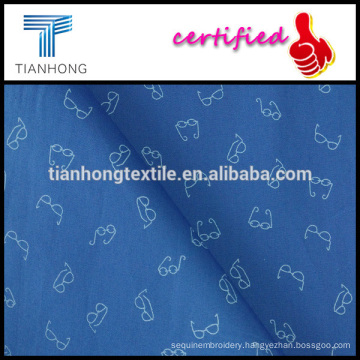 light weight blue background glasses design printed on poplin weave cotton fabric for shirt